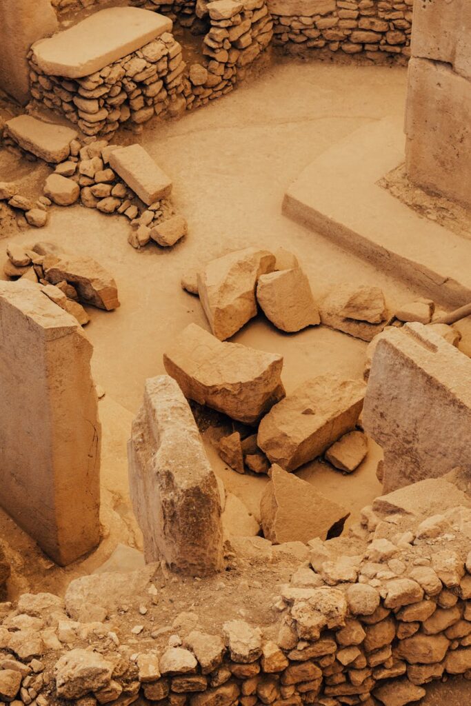 Ancient stone ruins with circular and rectangular structures at a desert archaeological site