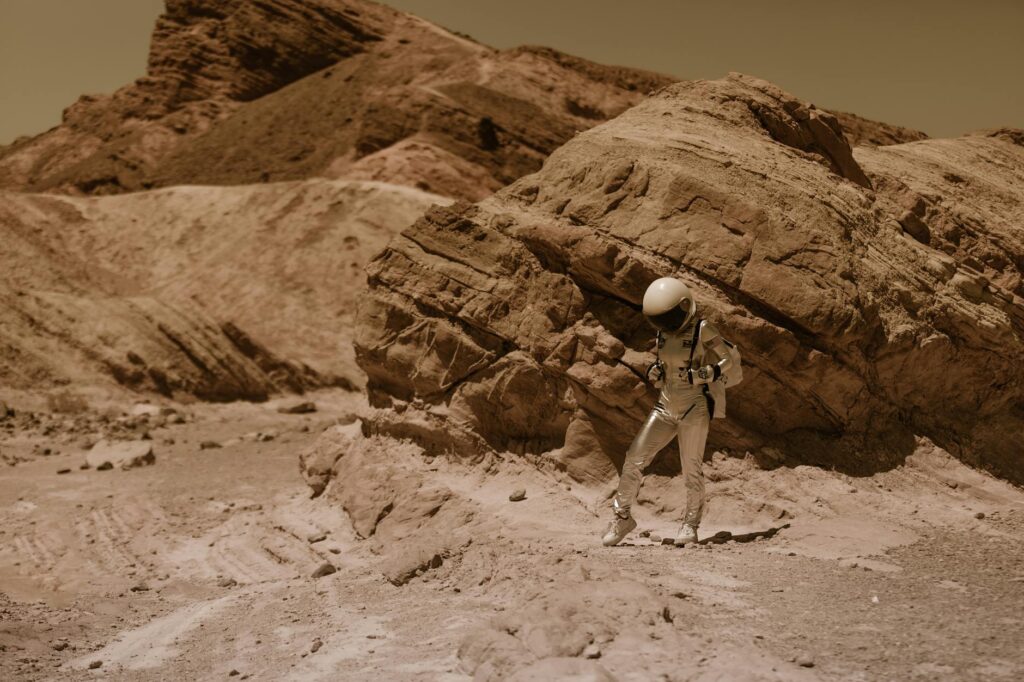 Astronaut exploring rocky terrain on a barren Mars-like planet. (Incomplete: max_output_tokens)