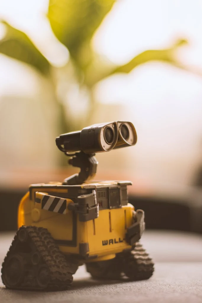 Close-up of a WALL-E robot toy against a blurred background.