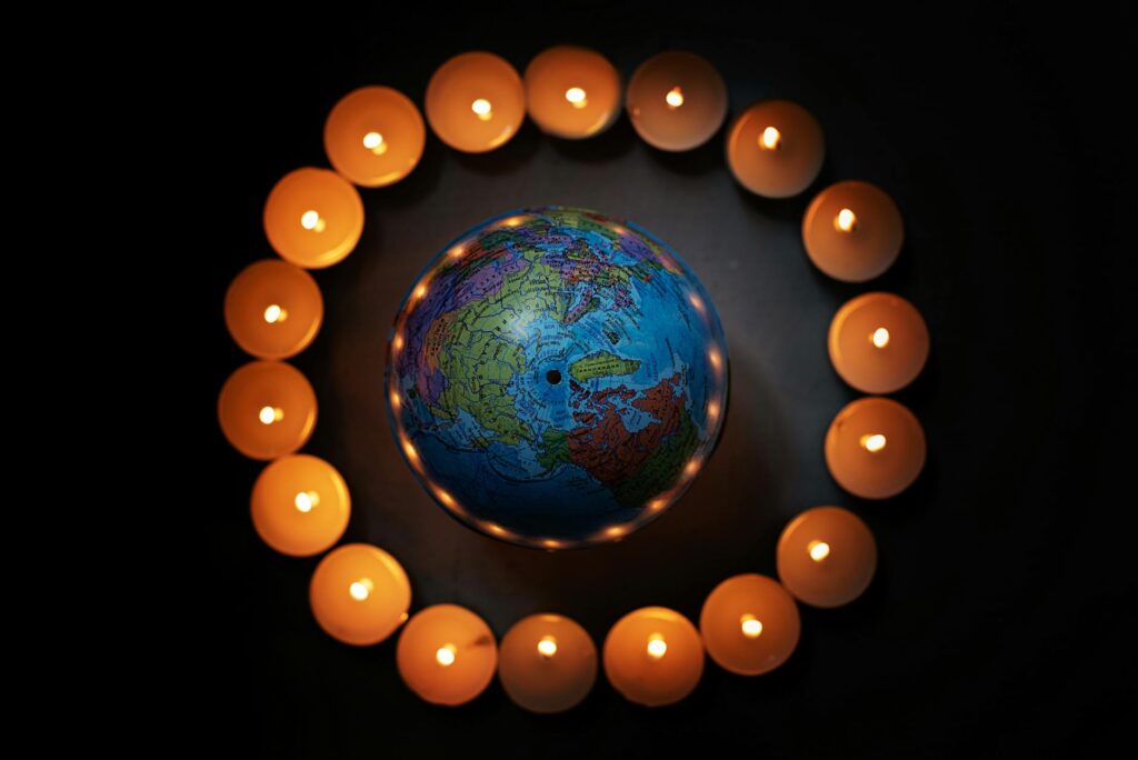 Globe encircled by lit candles in a (Incomplete: max_output_tokens)