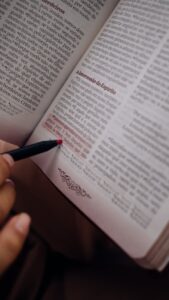 Close-up of person highlighting text in a book with a pen. (Incomplete: max_output_tokens)