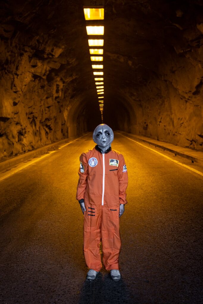 Person in astronaut costume standing in a dimly lit tunnel