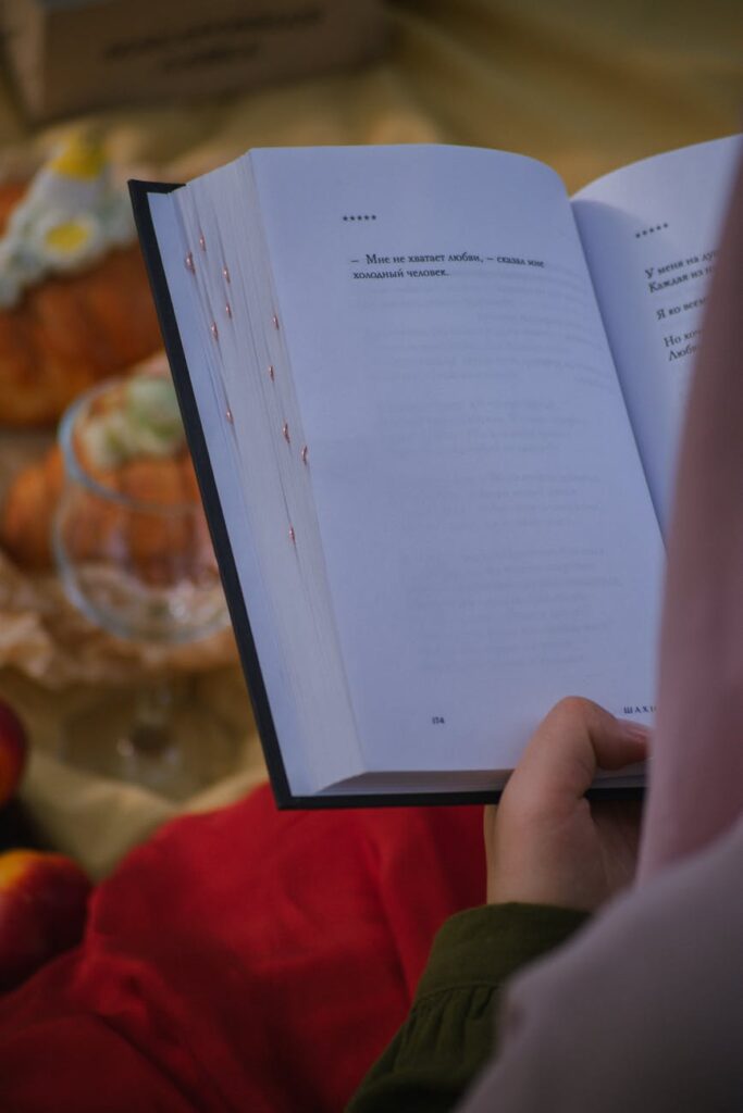 Person reading an open book about machine learning with blurred background