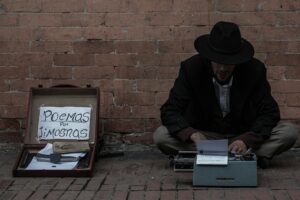Street poet typing poems on a vintage typewriter beside a brick wall
